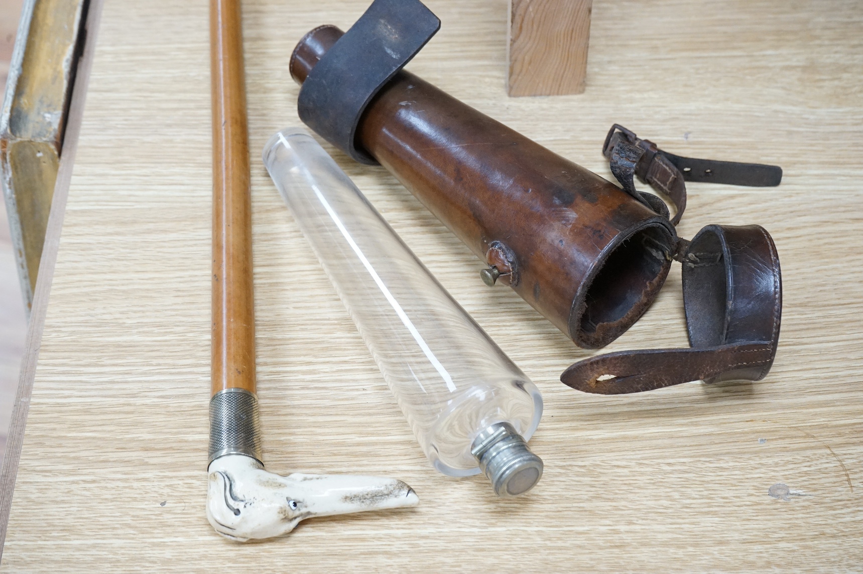 A riding crop with carved stag antler dog’s head handle together with a leather cased riding flask, 79cm. Condition - fair to good